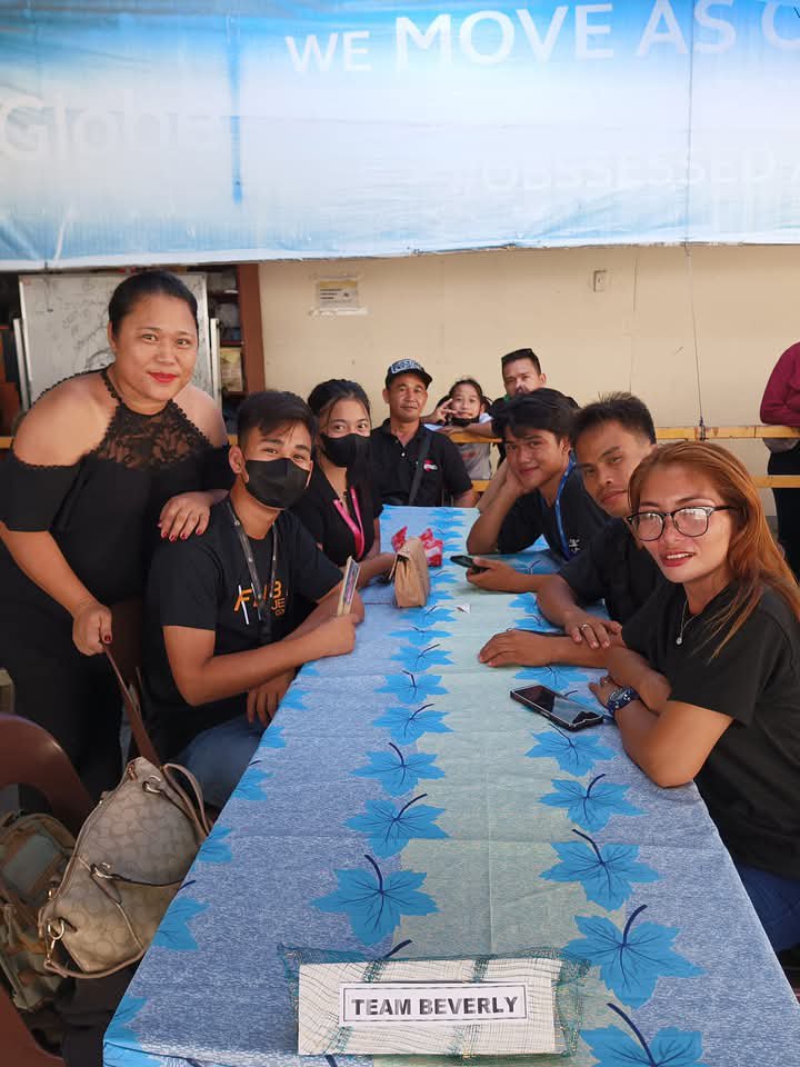 GNP1 Inc. Globe Broadband Telecom teammates gathered around a table as Team Beverly